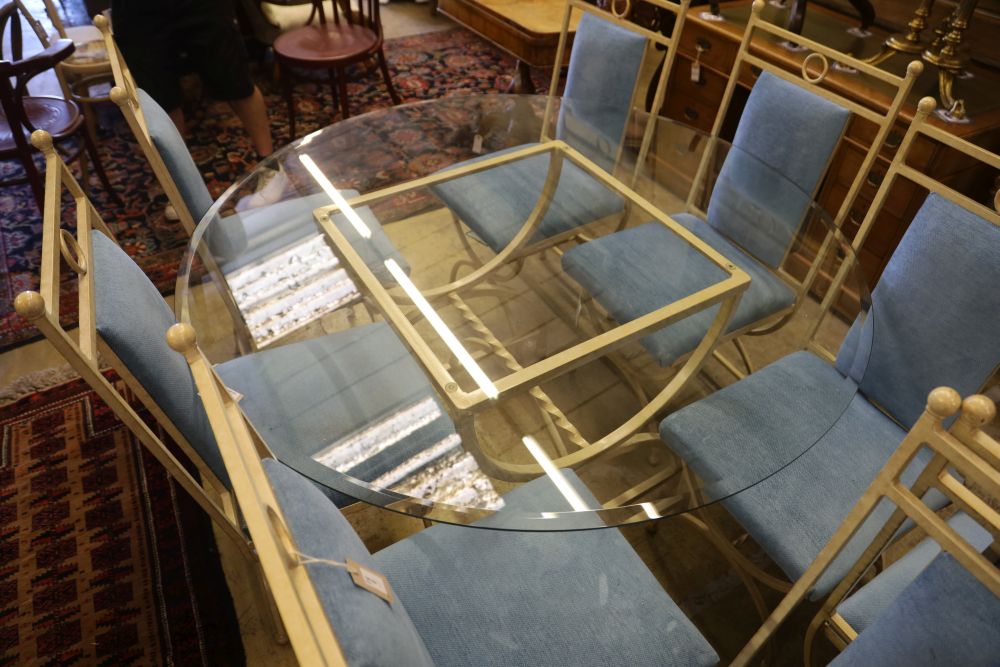 An enamelled metal dining suite comprising a circular glass-topped table and a set of eight chairs, table 138cm diameter